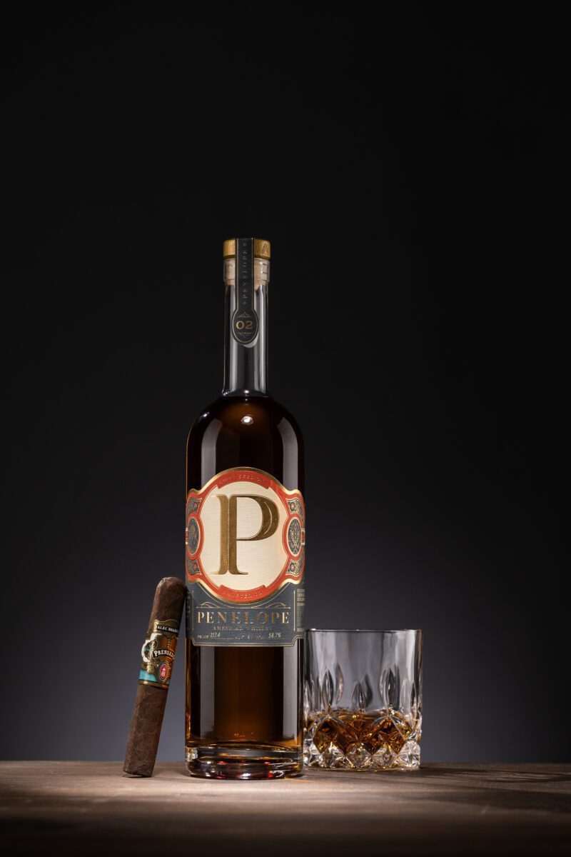 Penelope Cigar Session 2 with a cigar and a glass of whiskey