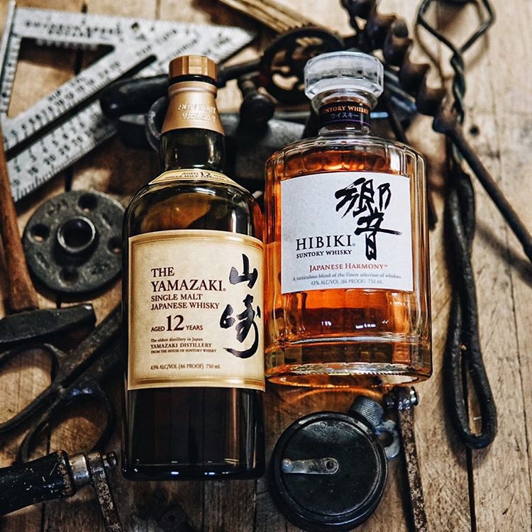 two bottles laying on tools.