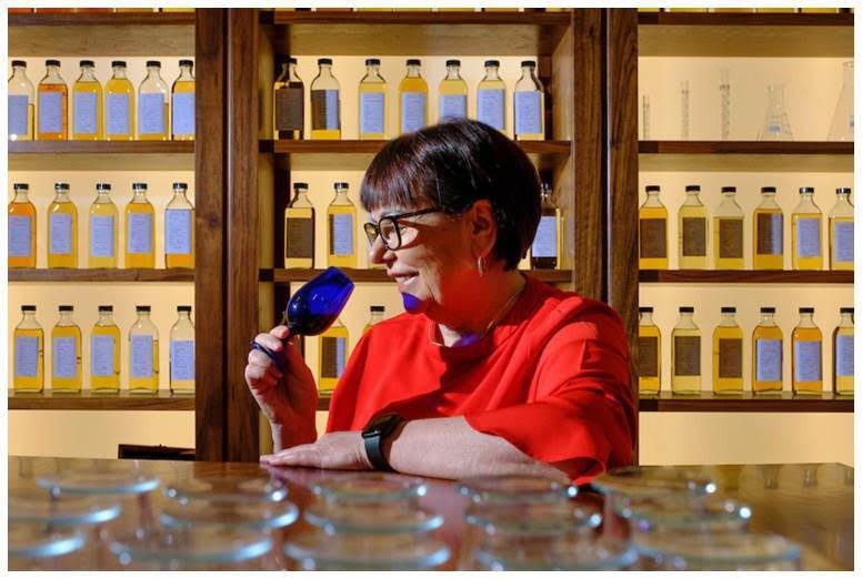 Maureen Robinson sniffing a glass